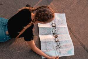 Young woman reading a roadmap Young woman reading a roadmap